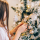 Adorable little girl decorating a Christmas tree with baubles at home - PhotoDune Item for Sale