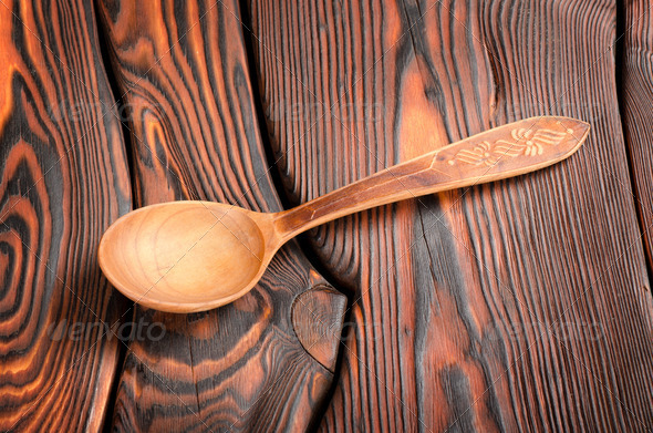 Wooden spoon on the wooden background