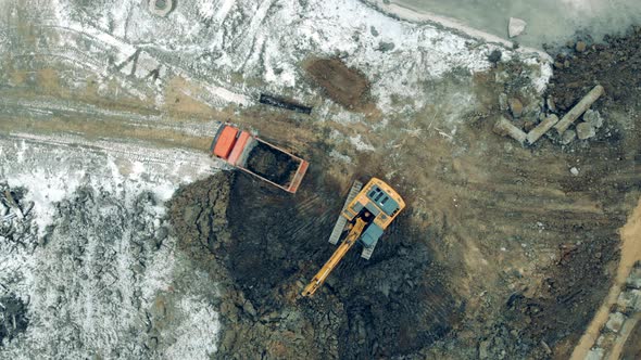 Industrial Machinery Working at a Construction Site. Many Tractors Move Sand and Earth While Working alt