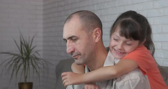 Relaxing Child and Dad on Sofa alt