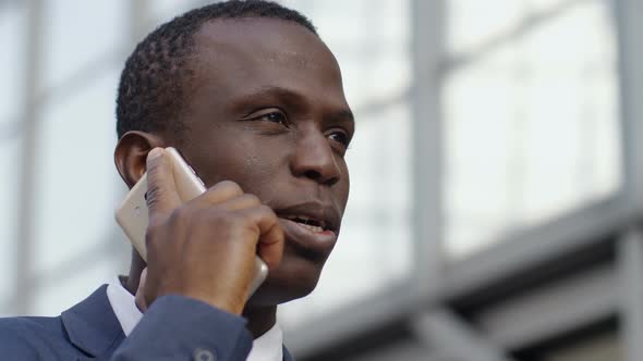 Black African Young Business Man Talking by Phone- Close up Portrait alt