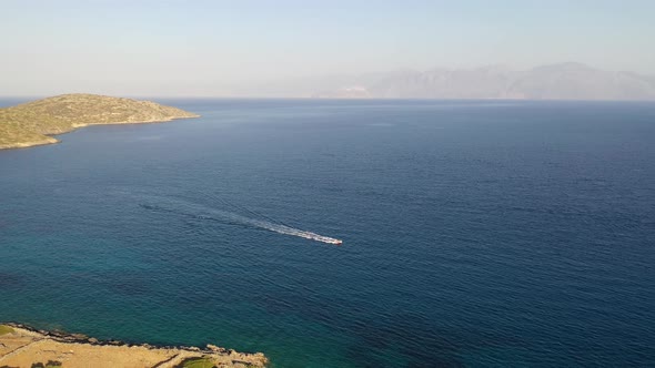 Aerial View of a Motor Boat Towing a Water Skier. Elounda, Crete, Greece