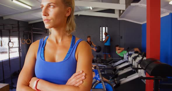 Beautiful woman standing with arms crossed alt