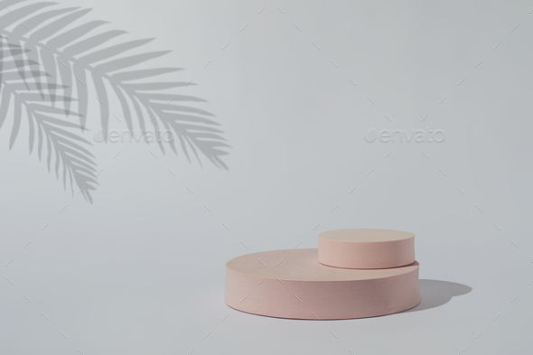 Mock up pedestal stand podium for demonstration and display of cosmetics and palm tree shade - Stock Photo - Images