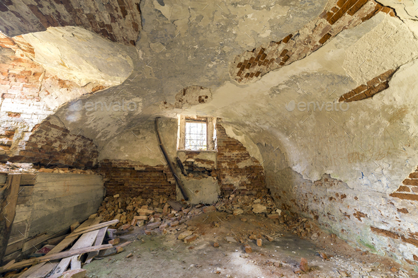 Old forsaken empty basement room of ancient building or palace with cracked plastered brick walls - Stock Photo - Images