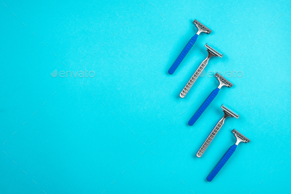 Blue disposable razors isolated on blue background
