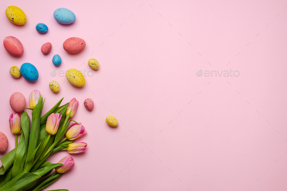 Easter background with colorful eggs and yellow tulips over wood. Top ...