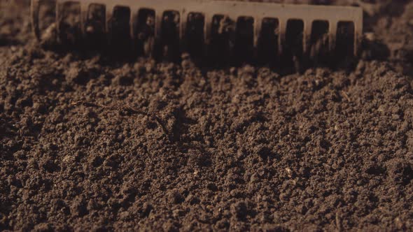 Soil Being Raked In Garden alt