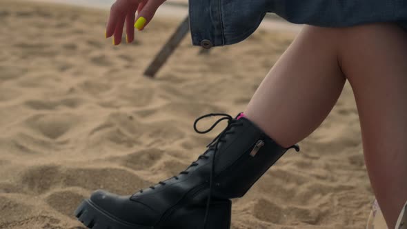 Girl Legs Wearing Black Boots Lying Seashore Sand Close Up alt