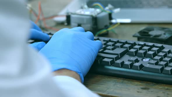Close-up of robotic engineer using desktop pc at desk 4k alt