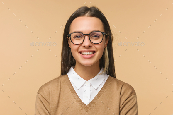 Beautiful smiling female college teacher isolated on brown background