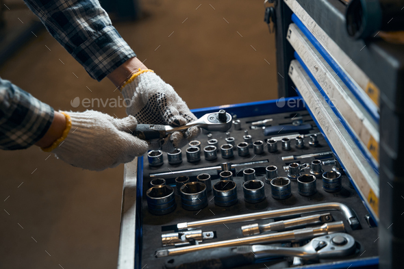 Skilled mechanic choosing needed tools for the job