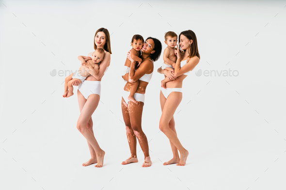 Shot Of A Beautiful Pregnant Woman Wearing Underwear And Holding