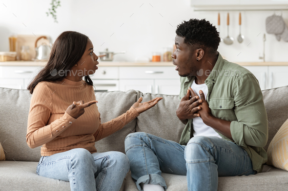 Emotional black husband and wife having fight at home