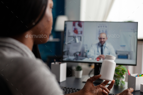 Woman with disease using video call on monitor for telehealth - Stock Photo - Images