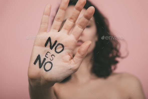 Woman\'s hand with vindictive painted letters. No means no concept.