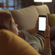 Girl relaxing on the couch and connecting with her smartphone - PhotoDune Item for Sale