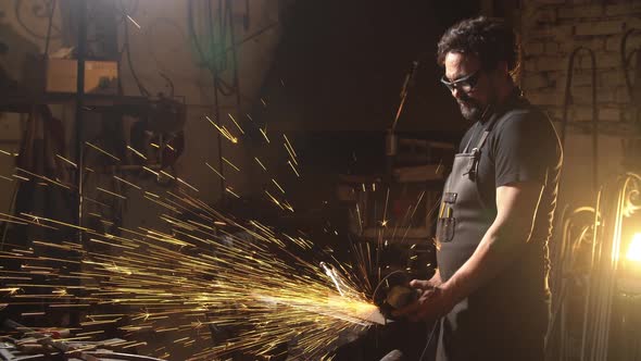 Man of a Blacksmith in the Working Atmosphere. Slow Motion
