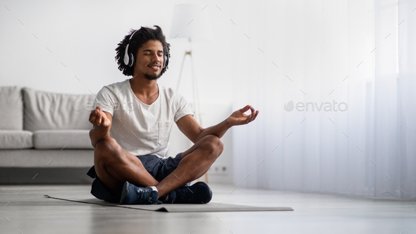 Meditation Practice. Relaxed Black Man Meditating At Home In Lotus Position
