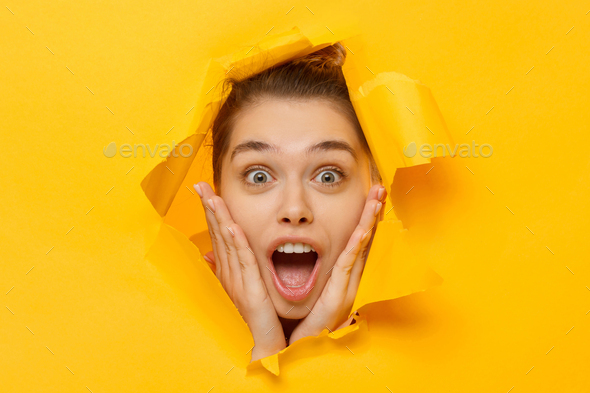 Close-up portrait of young excited woman shocked and amazed by commercial offer