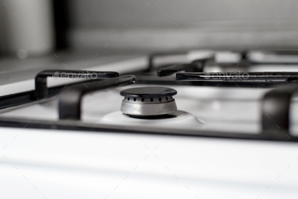 Gas burner close-up, selective focus. Indoor gas stove surface