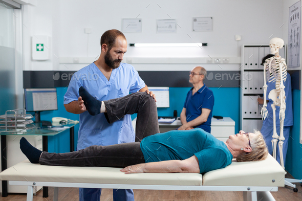 Chiropractor stretching leg muscle to relieve pressure Stock Photo by ...