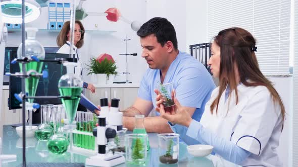 Researcher in Biology Field Talking with an Intern alt