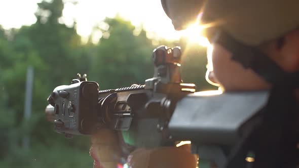 Player Is Shooting Airsoft: Reloads His Weapon and Shoots.