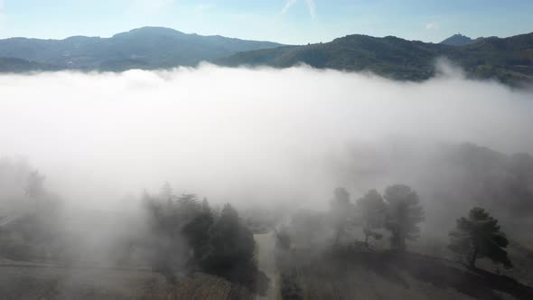 Drone view of foggy hills in Umbria, Italy