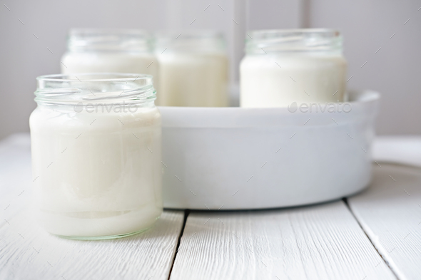 homemade organic yogurt in glass jars in yogurt maker.
