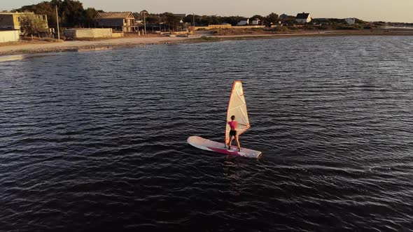 Aerial View of a Sportive Young Woman Learning To Fly a Windsurf Board alt