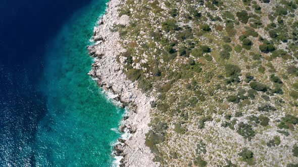 Aerial View of Clear Turquoise Water Near the Rocky Coast of the Aegean Sea alt