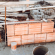 industrial bricklayer installing bricks on construction site - PhotoDune Item for Sale