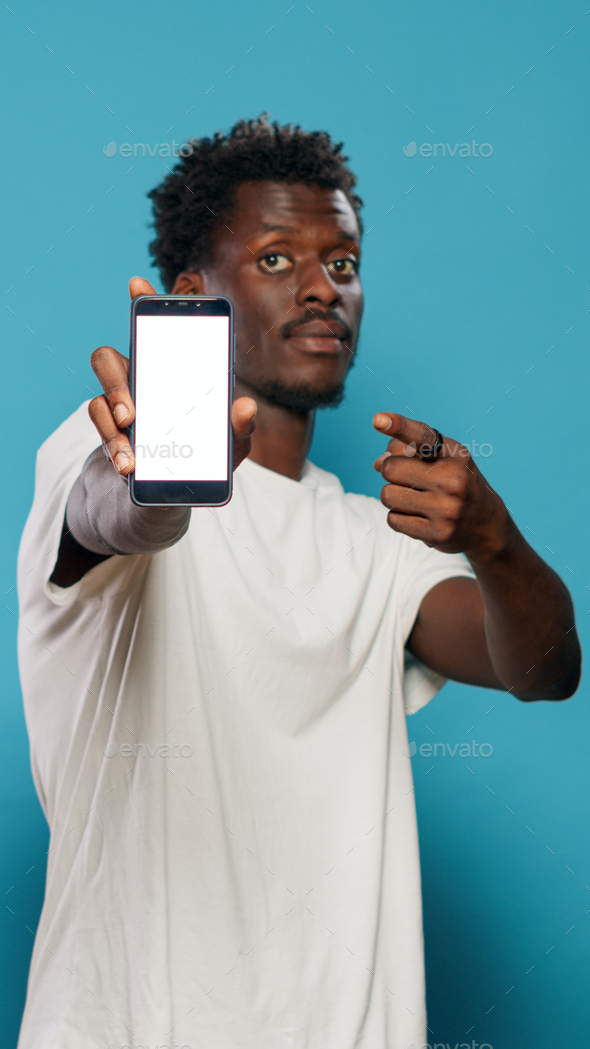 Man using smartphone display and showing white screen to camera Stock