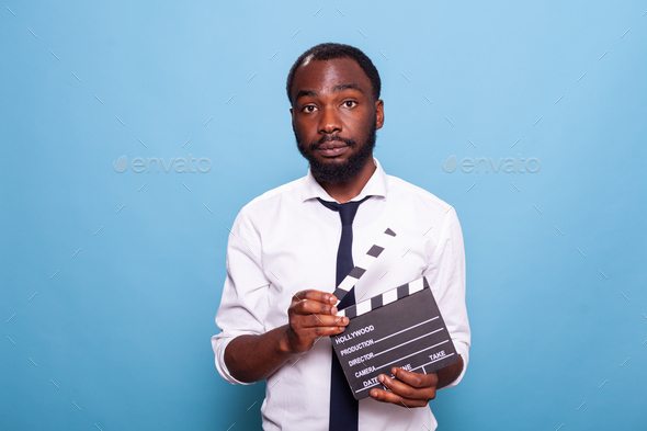 Indie african american movie producer with open clapperboard in hands