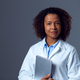 Studio Portrait Of Female Doctor In Lab Coat Holding Digital Tablet - PhotoDune Item for Sale