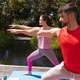 Young man and woman exercising together in park on sunny day - PhotoDune Item for Sale