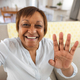 Happy african american senior woman waving hand during video call at home - PhotoDune Item for Sale