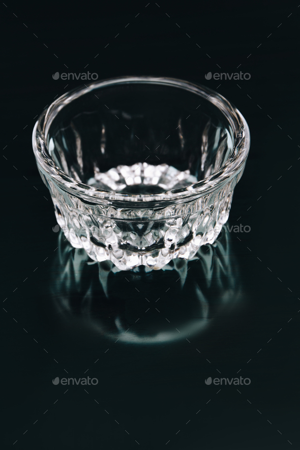 Empty glass ashtray on dark background. - Stock Photo - Images