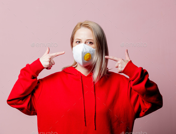 Woman in FFP2 anti-dust standart face mask on pink background