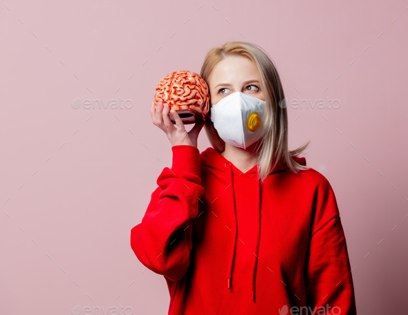 Woman in FFP2 anti-dust standart face mask hold human brain