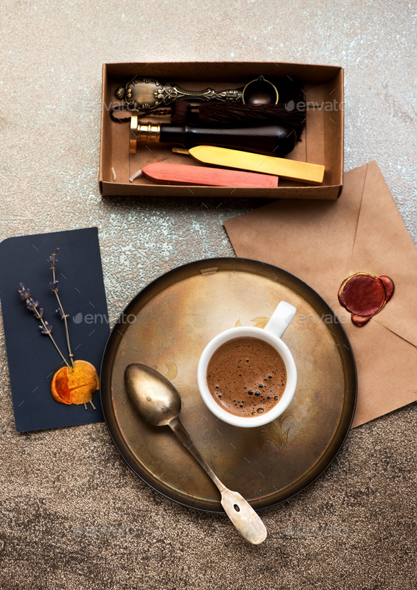 Retro still life with cup coffee, envelope with wax stamp and wax seal