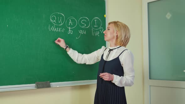 Teacher near the blackboard alt