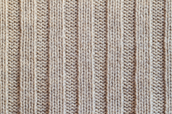 Beige knitting wool texture background. Woolen handmade knitted