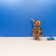 Robot game. Mechanical robot pulls a miniature plastic car automobile on a rope. - PhotoDune Item for Sale