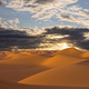 Sunset over the sand dunes in the desert. Arid landscape of the Sahara desert - PhotoDune Item for Sale