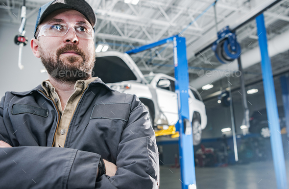 Proud and Satisfied Car Mechanic Inside an Auto Service - Stock Photo - Images