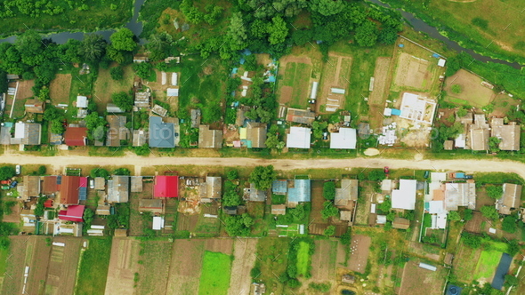 4K Aerial View Of Small Village. Houses And Vegetable Gardens. Potato Plantation At Summer Day
