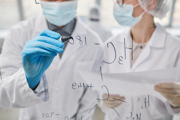 Scientists working with formulas in team - Stock Photo - Images