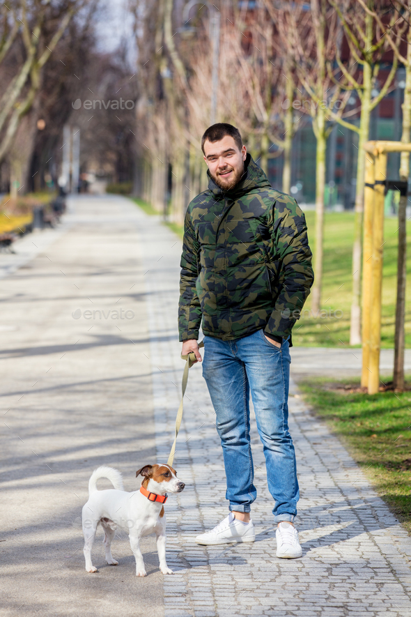Young man with his dog, Jack Russell Terrier - Stock Photo - Images